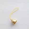 Detailed close-up of a 2cm golden metal Christmas bell with a yellow hanging cord - 2cm Gold Bell (Yellow Rope)
