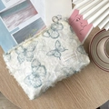 Off-white puff cosmetic bag with blue butterfly patterns and a metal zipper ring - Lace Butterfly Storage Bag - Dark Green