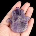 Hand-carved purple amethyst Hamsa hand ornament with engraved eye pattern crystal detail - Amethyst