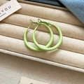 Detail of lime green matte round hoop earrings presented in a cream jewelry box - Lime Green