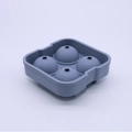 Grey 4-hole silicone ice ball mold for spherical ice cubes on white background - 4-Sphere Morandi Blue