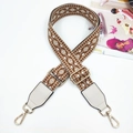 Close-up of ethnic geometric diamond pattern bag strap with gold metal hardware - Dark Brown + White Leather