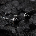 Macro shot of minimalist S925 sterling silver studs with round black stone on dark rock - Natural Black Agate Round Silver 5mm