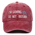 Close-up of embroidered gaming text and controller icon on washed cotton baseball cap - Burgundy