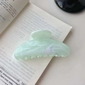Elegant light green marble texture hair claw clip on an open book for vacation style - Green