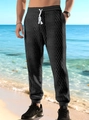 Pantaloni jogger neri da uomo in tessuto jacquard con coulisse su spiaggia tropicale - S / Nero