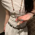 Bohemian style necklace with wood beads and pink fabric flower on white lace dress - Coffee Ethnic Flower Style