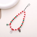 Close-up of Christmas phone charm with red green white beads and festive pendants - Colored Beads