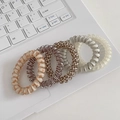 Set of 5 spiral hair ties with checkered and solid patterns on a laptop keyboard - 2# Yellow Spiral (5pcs Set)