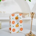 Mini white paper gift bag with orange pattern and flat fold closure in cozy setting - Orange