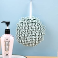 Light green chenille hand drying ball with hanging loop on a blue wall background - Bean Green