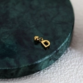 Polished gold initial D pendant charm on green marble tray with sleek metal finish - Letter Pendant (D) / Gold