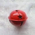 Red 5cm metal Christmas bell with star cutouts on soft white plush background - Star Painted Red