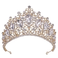 Detail of golden Baroque wedding tiara featuring red crystals and intricate scroll patterns - KC Gold White Rhinestone