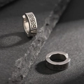 Macro shot of silver titanium steel ear clip with black Greek fret pattern on stone - Silver Greek Key Pattern