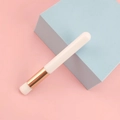 Portable eyelash cleansing brush with white handle and rose gold ferrule on pink background - White