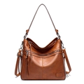 Close-up of caramel brown leather tote bag showing vintage textures and dual tassel zippers - Single Bag / Brown