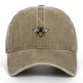 Close-up detail of vintage washed baseball cap with premium embroidered bee insect design - Khaki