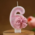 Pink glitter number 6 birthday candle with a cute bow decoration on wooden base - Number 6