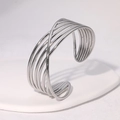 Detailed view of silver minimalist crisscross metal cuff bracelet on white display stand - Steel Color (SZ103)