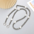 Luxury black and silver crossbody phone chain with pearls and rhinestones on a desk - Rhinestone Ring Crossbody Chain / Black