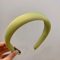Puffy light green sponge headband with matte satin finish held in hand - Olive Green