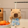 Cute brown capybara plush keychain wearing blue floral shorts with a green plastic clip - Capybara
