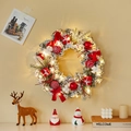 Illuminated Christmas wreath with snowy pine needles, red ornaments and warm LED lights - Snow-flocked Wreath With LED Lights