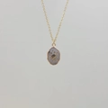 Detailed view of a gold-plated necklace featuring a planet and star engraved pendant - Labradorite-Saturn