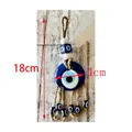 Blue glass Evil Eye hanging ornament with woven rope and six small spherical beads - 4cm Diameter Blue Eye