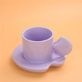 Ceramic coffee cup set in purple with a unique shell-shaped handle and matching saucer - Shell Shape Cup + Saucer - Purple
