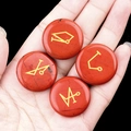 Set of 4 red jasper rune stones with gold engraved symbols held in palm on black background - Set of 4 / Red Jasper