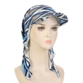 Detail view of the blue and white abstract print on a turban hat with brim and back ties - Blue Rhombus
