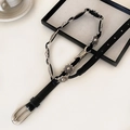 Detail of silver butterfly buckle and vintage geometric metal accents on leather belt - Sunflower Black Leather Style