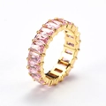 Macro side view of rectangular pink zircon crystals on a polished gold eternity ring band - Gold Pink Zirconia