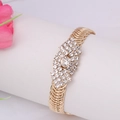 Detailed macro shot of vintage gold evil eye bracelet with white crystal rhinestones - White