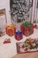 Three red grid Christmas gift boxes with festive glitter bows in gold, blue, and green - Red Gold Silk Christmas Gift Box
