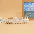 Detailed view of a white and gold wooden Christmas train with snowmen and gift box miniatures - White
