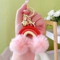 Bohemian rainbow keychain with red and beige woven rope and pink pom poms on gold ring - Red