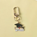 Golden graduation cap and scroll keychain gift for students with GRADUATE lettering - Style 2 (Gate Buckle)