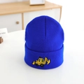 Detailed close-up of yellow excavator embroidery on royal blue ribbed knit beanie hat - 52-54cm / Blue