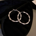 Macro detail of silver twisted hoop earrings with glossy finish on black velvet display - Silver Twisted Small (70#)