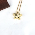 Detailed close-up of golden star pendant with crystal encrusted Y letter on white texture - Letter Y