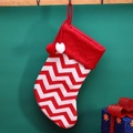 Knitted red and white wave pattern Christmas stocking with pom-poms on a wooden rack - White Stripe Sock