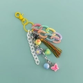 Close-up of Y2K acrylic keychain with colorful tassels, heart and butterfly charms - Yellow