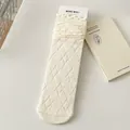 Creamy white JK crew socks featuring diamond knit patterns and ruffled lettuce edges - With Cardboard / White Argyle