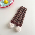 Detail of plaid knit scarf with soft white pom-poms and high-quality wool texture - Coffee Khaki Plaid