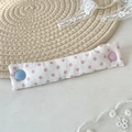 Close-up of pink polka dot fabric cable organizer with blue and heart shaped buttons - Pink Polka Dot