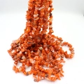 Natural orange-red irregular crushed stone beads for handmade jewelry crafts on white background - Red Agate approx 80cm