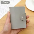 Compact gray lychee textured faux leather card holder with secure silver snap closure - 24 Slots / RFID Grey